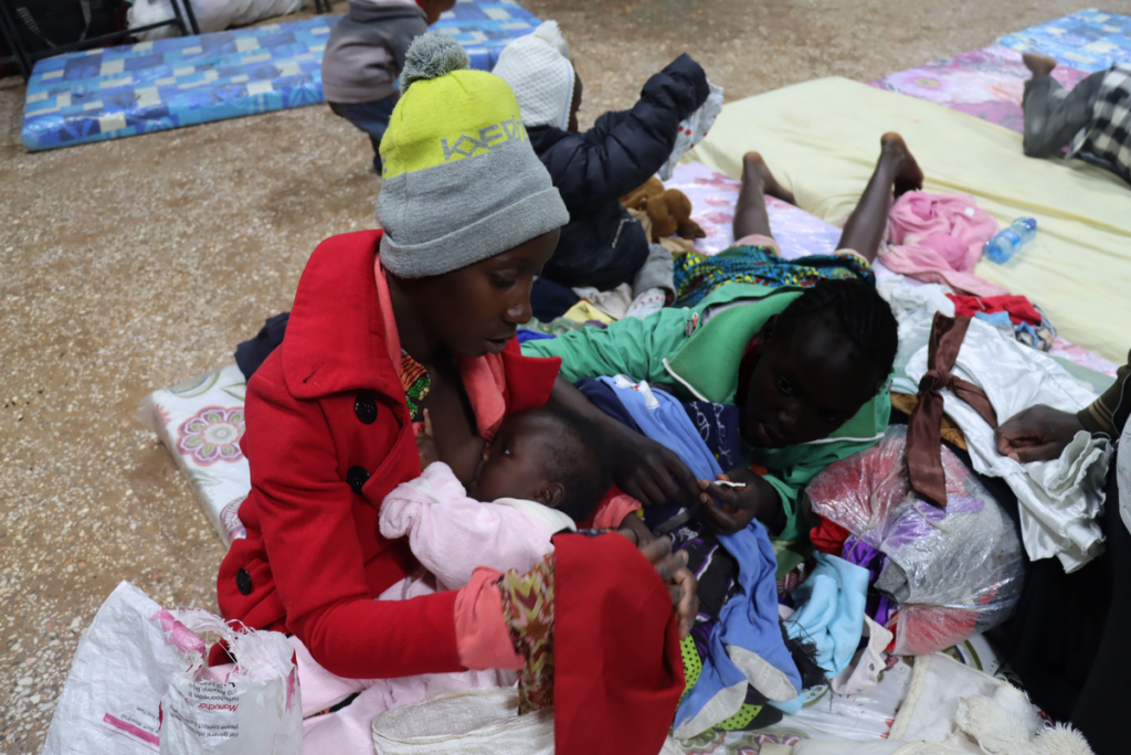 Maureen Njambi et ses enfants ont perdu leur maison dans les inondations qui ont ravagé le Kenya en mai 2024. Ils sont dans un camps temporaire, où ils recoivent des services de santé et biens essentiels, attendant de reconstruire leur vie. Crédit : Amref Health Africa/Linda Mwendwa Kariuki